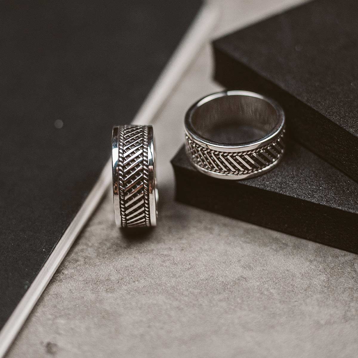 Two silver rings on top of a book.