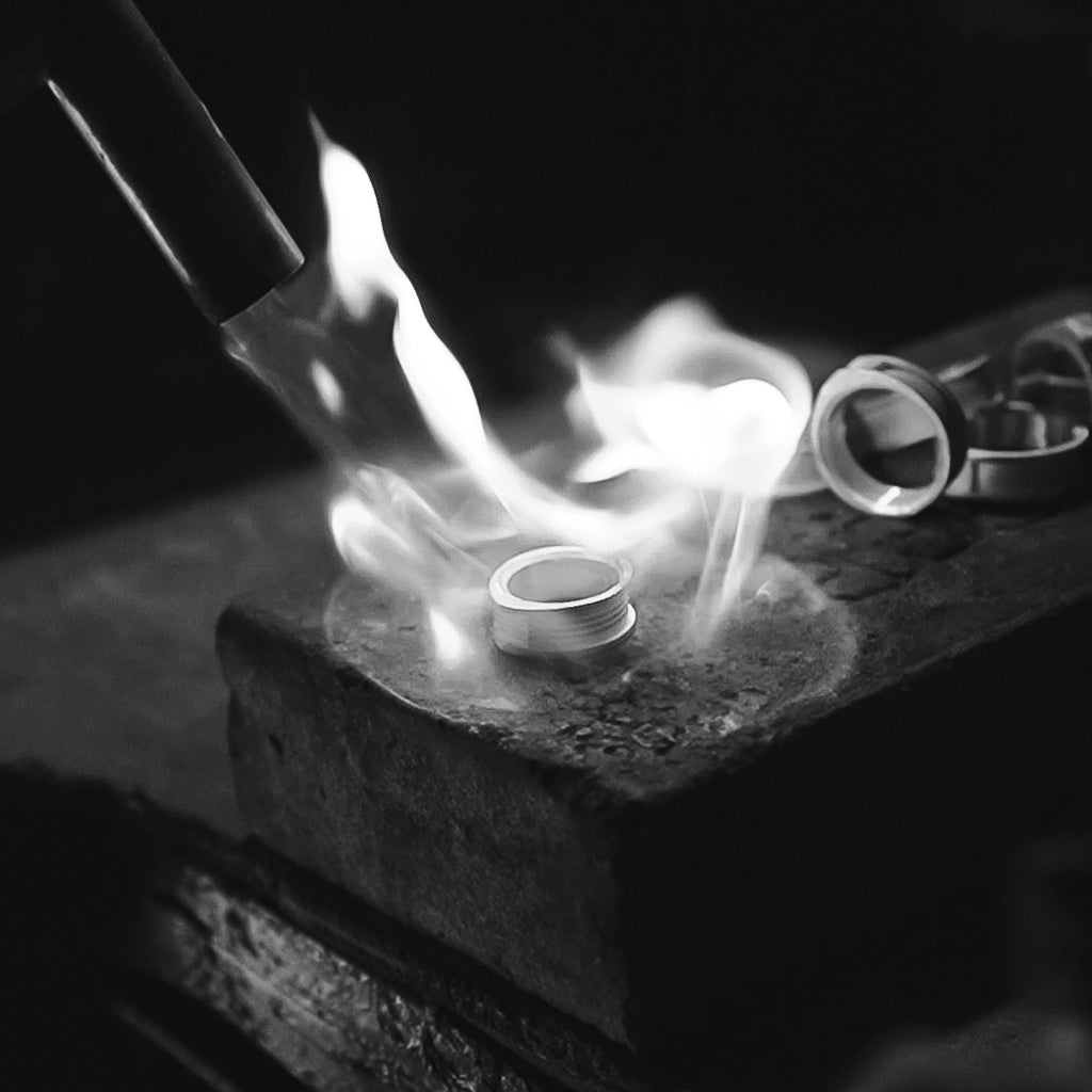 A photo of a ring being made with a torch.