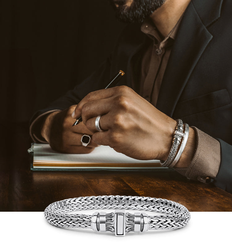 A man wearing sterling silver bracelet and a ring