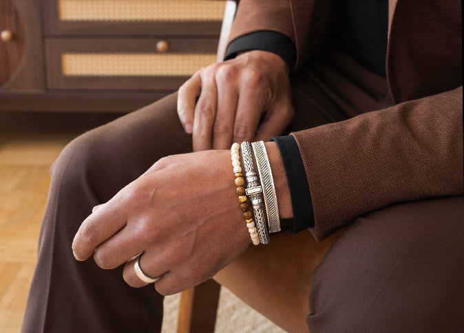 Man wearing a beaded bracelet, mens silver rings and bangles from Ninetwofive.