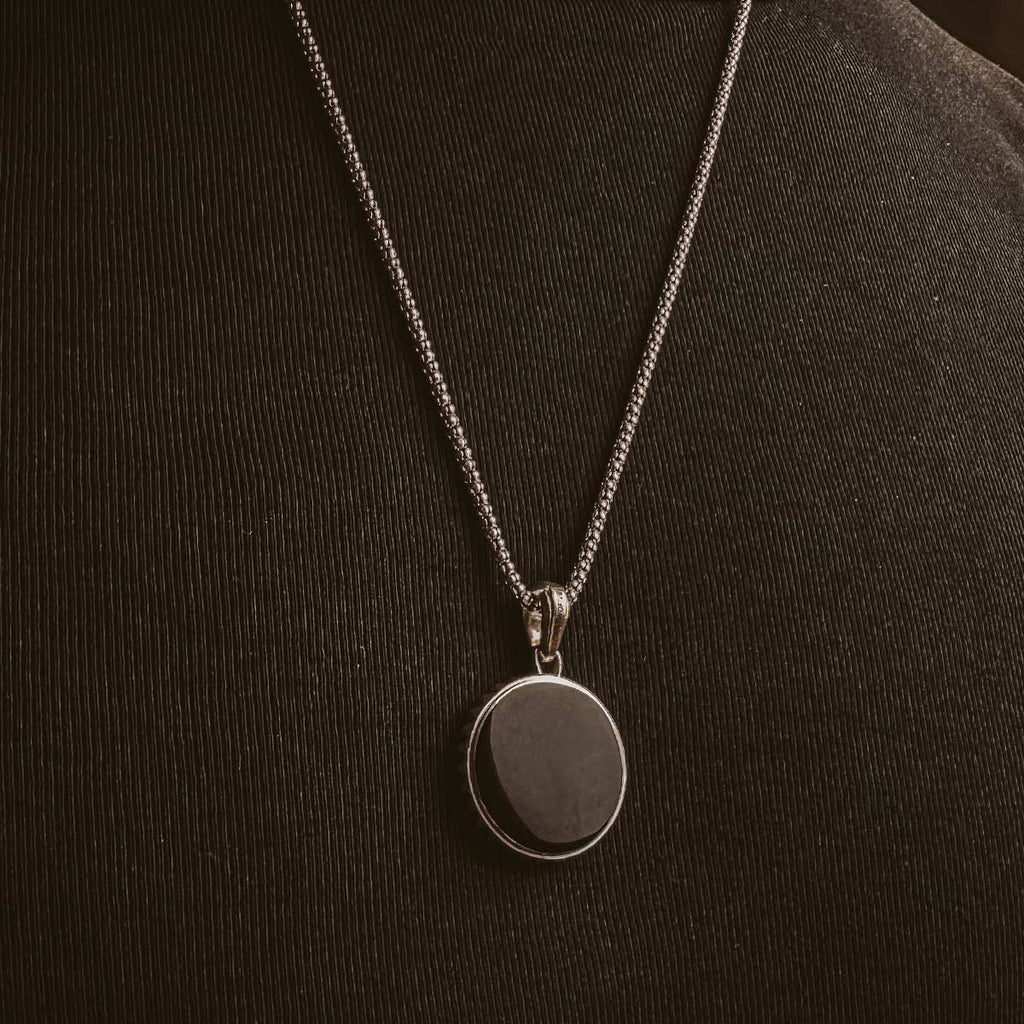 A man is wearing a Safar - Sterling Silver Onyx Compass Pendant necklace.