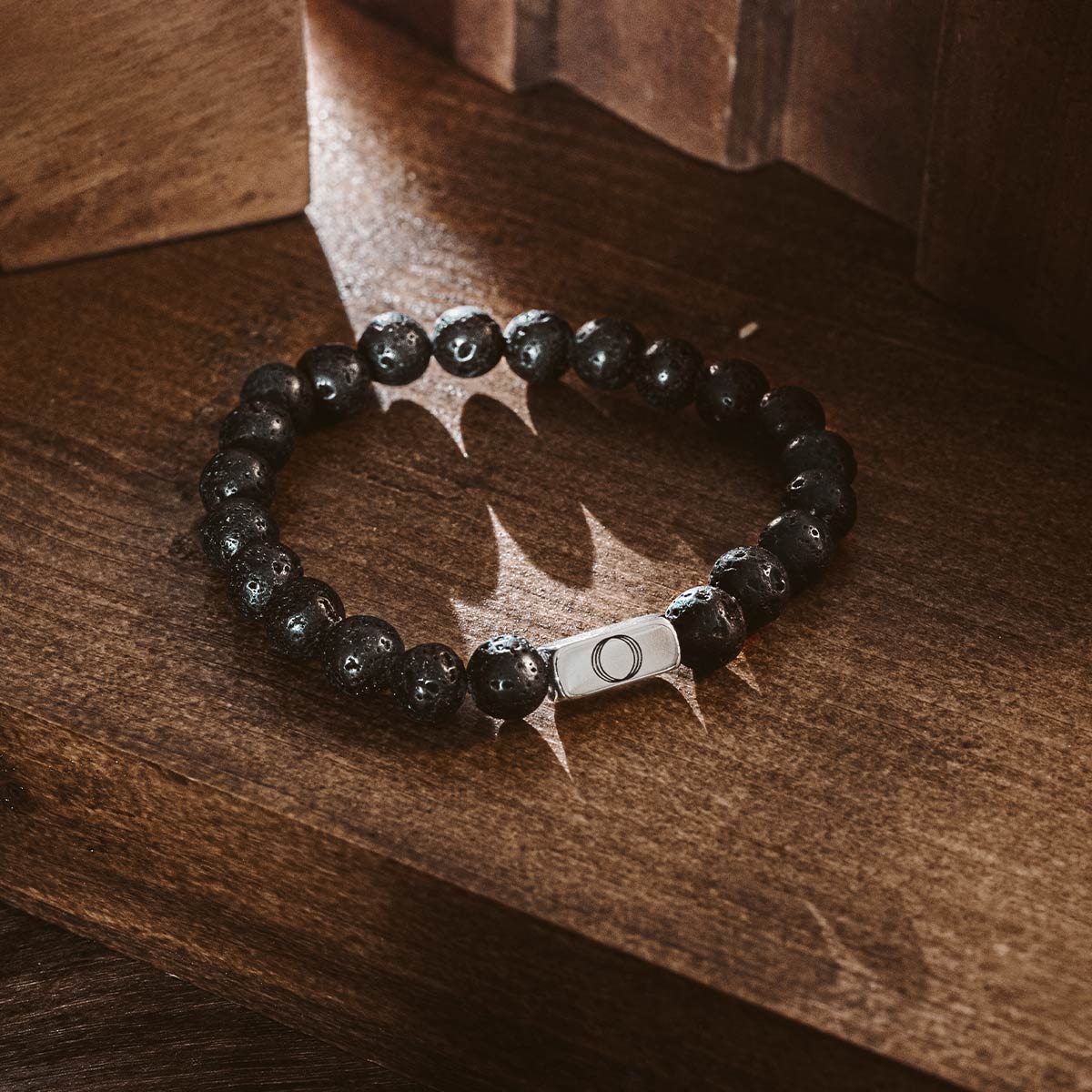 Halloween sale free men's black bracelet from ninetwofive on a volcanic rock.