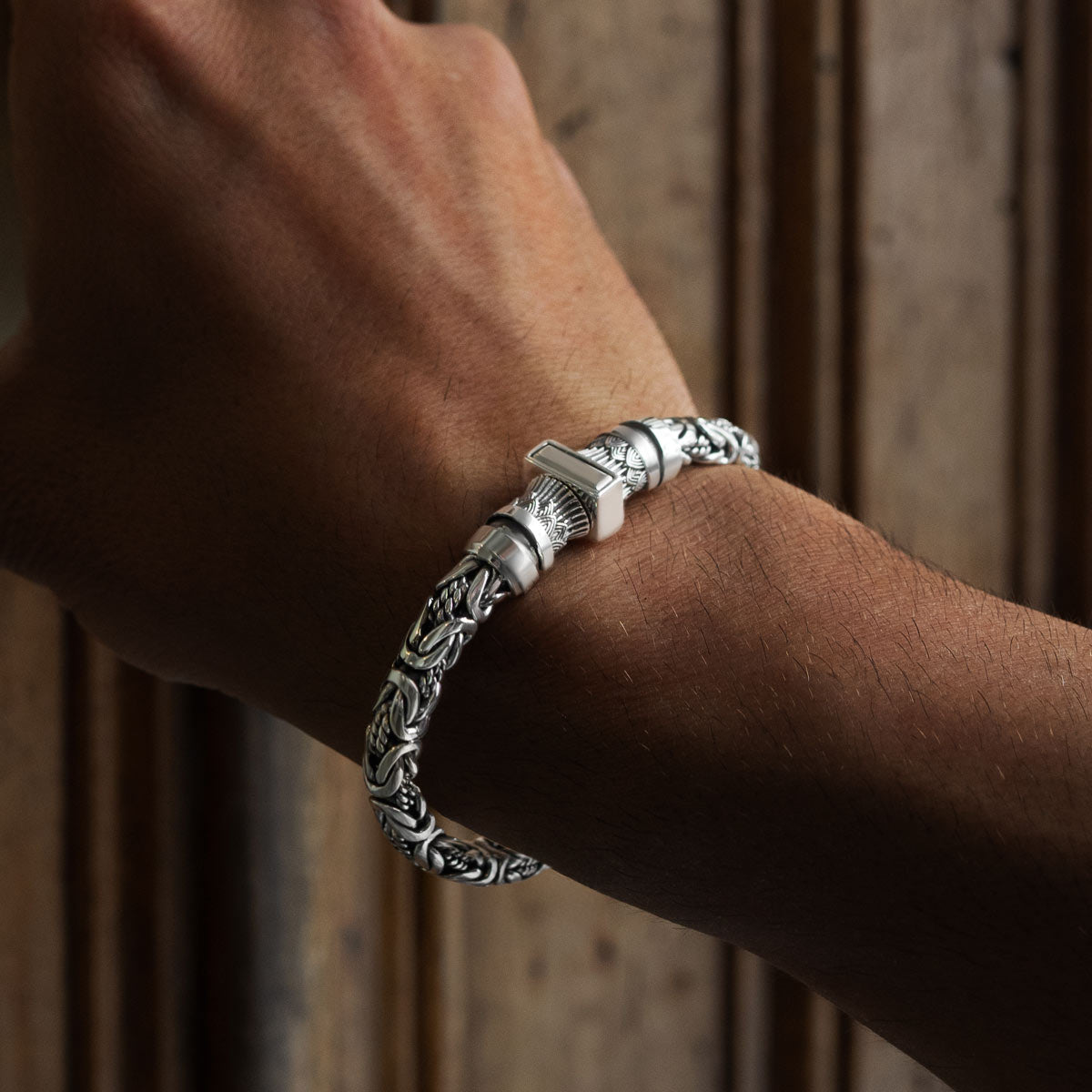 A model is wearing mens personalized silver Byzantine bracelet murtaza