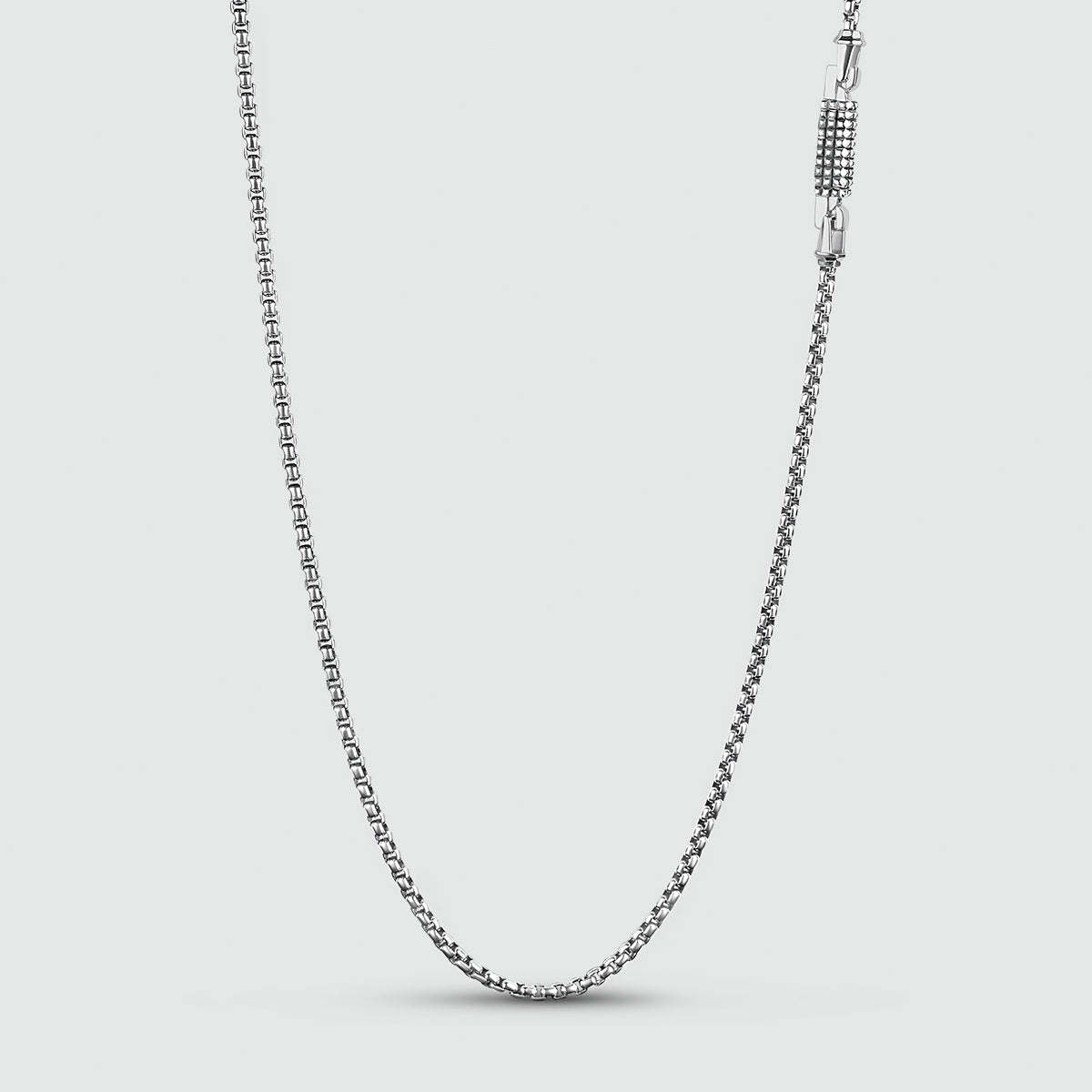 A handmade Kamal - Sterling Silver Box Chain Necklace 3mm with a clasp on a white background.
