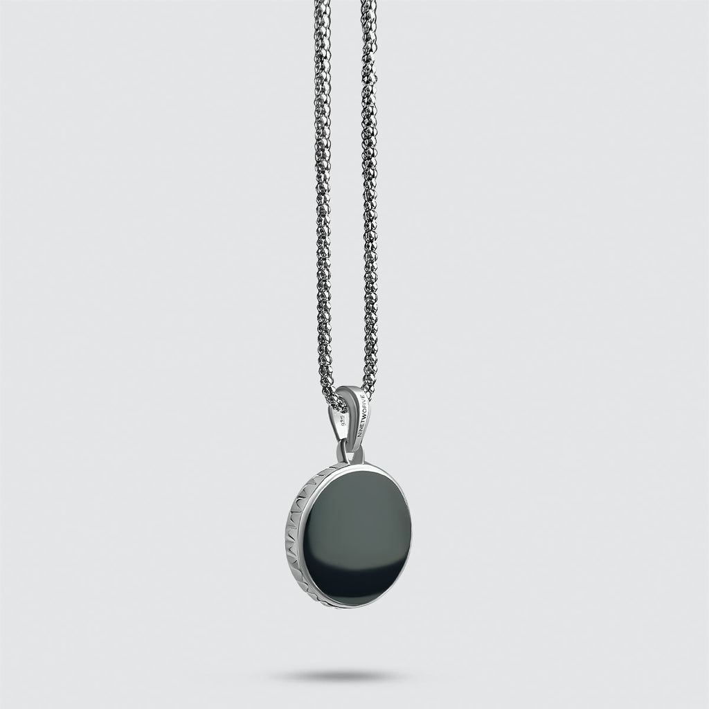 A pendant with a Safar - Sterling Silver Onyx Compass Pendant.