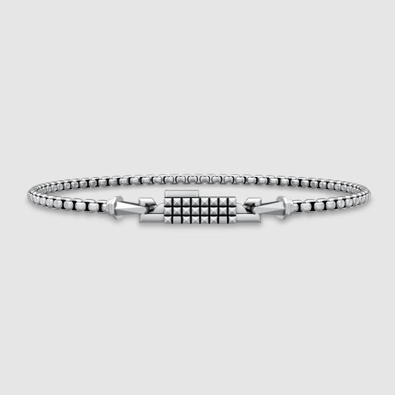 Silver box chain bracelet on a light gray background
