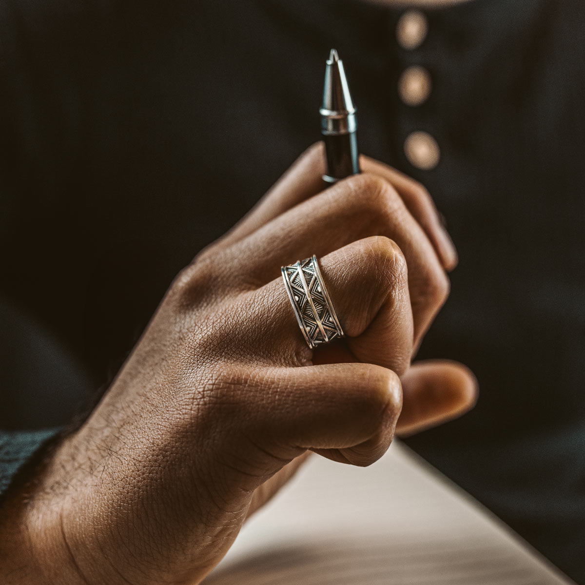 A model wearing a mens silver ring from NineTwoFive’s personalised jewellery collection
