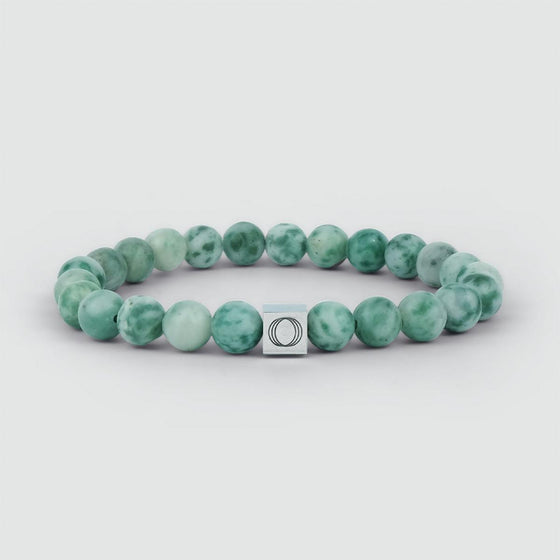 Front view of Ahkdir mens jade beaded bracelet, featuring a silver square charm engraved with the Ninetwofive logo.