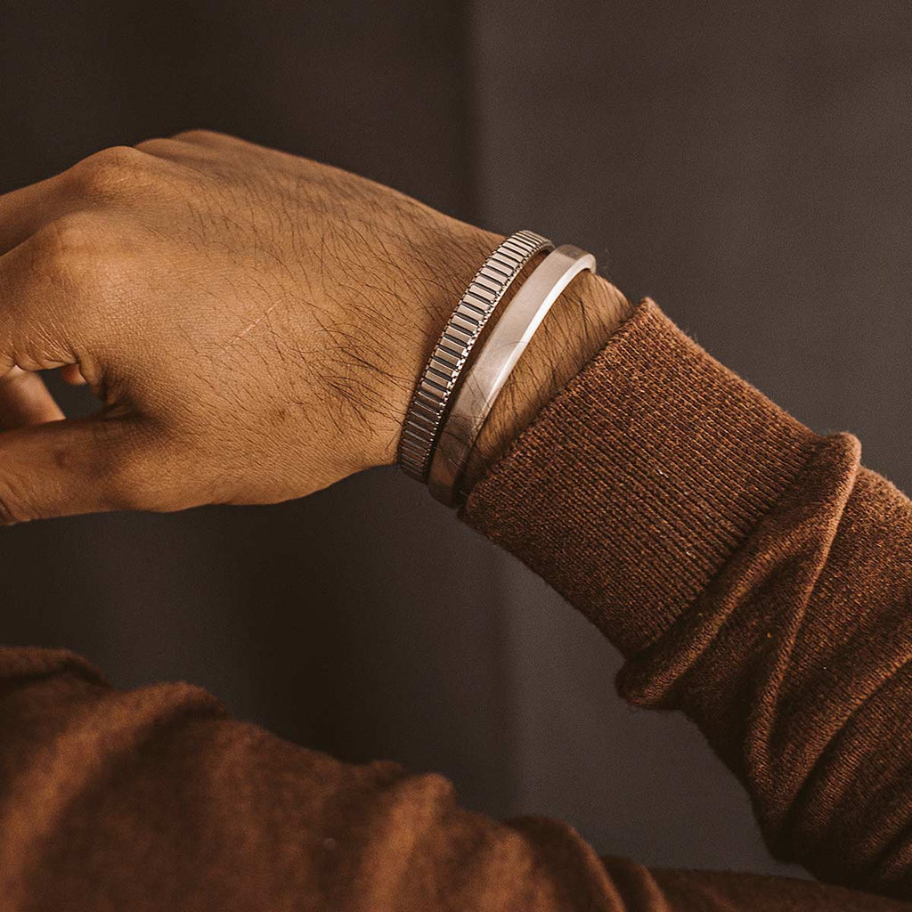 A man wearing a brown sweater and a Boulos - Plain Sterling Silver Bangle Bracelet 8mm cuff.