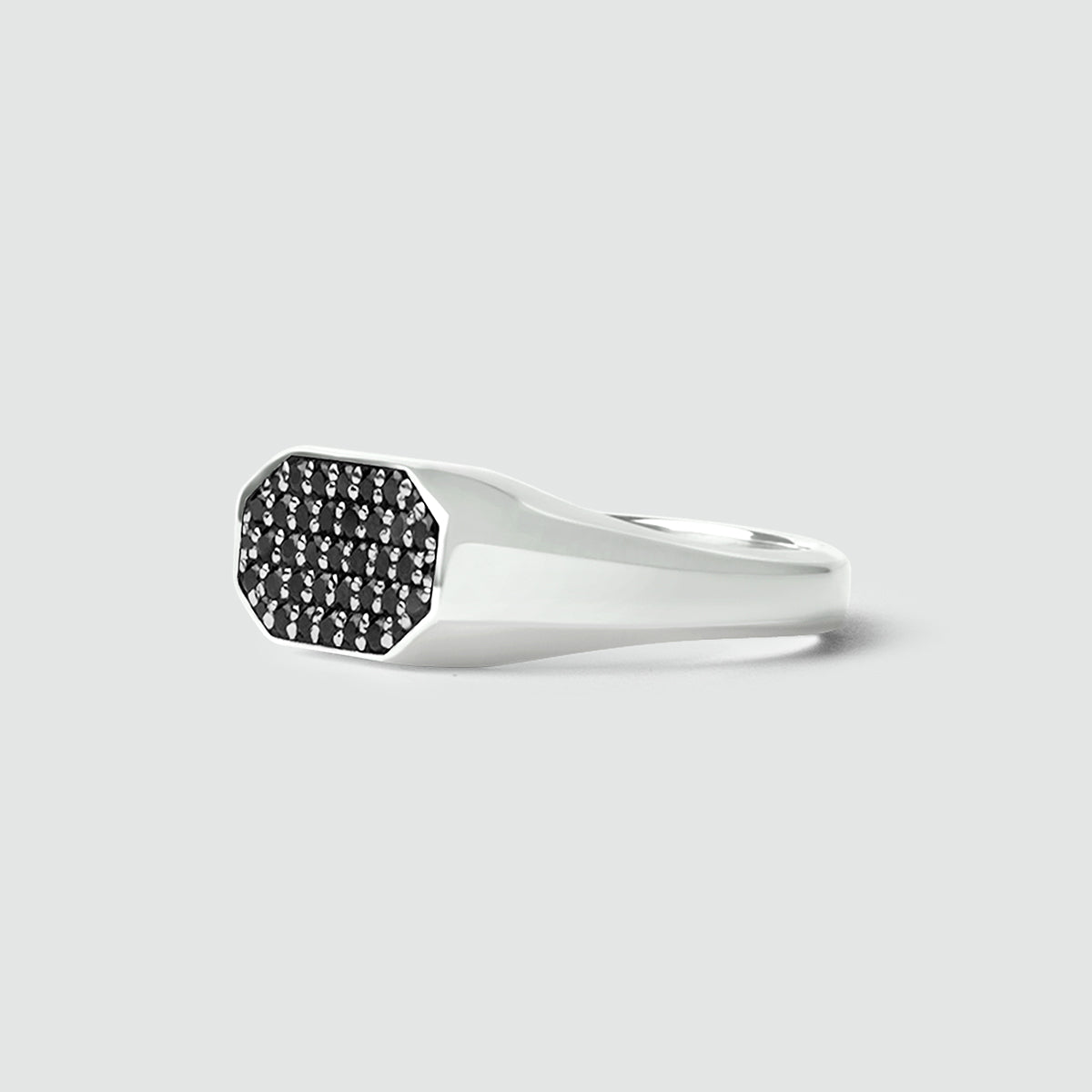 Mens 925 Silver ring with black gemstones on a light gray background