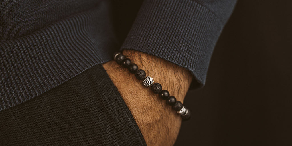A man wearing a black bracelet.