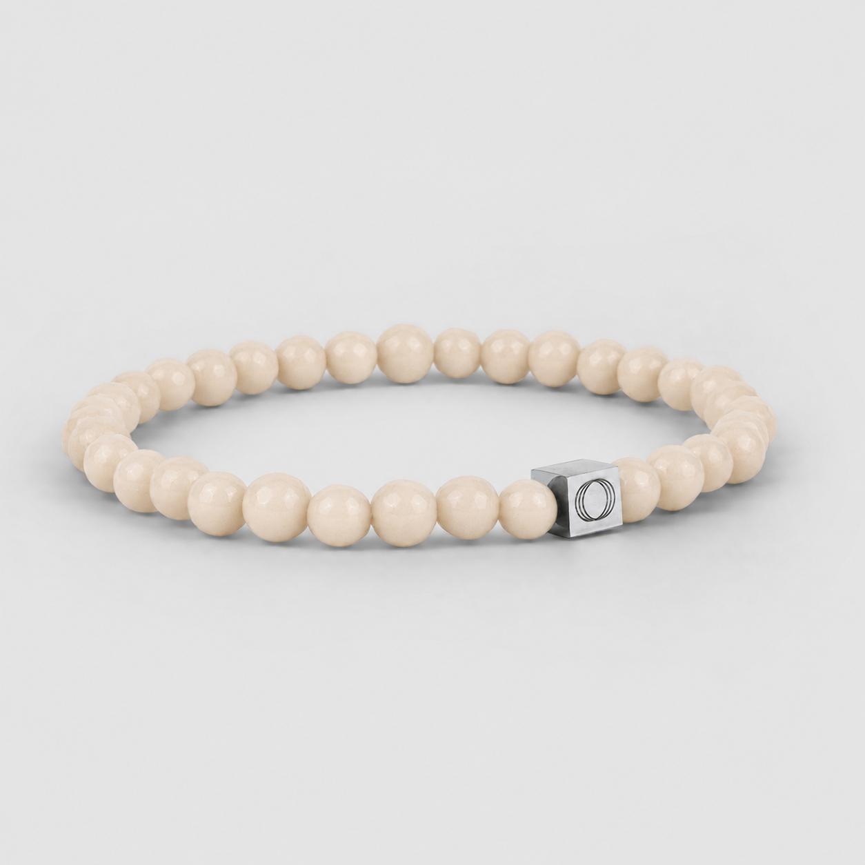 A grey stone bracelet with a silver clasp, carved out of Albij beige beaded bracelet.