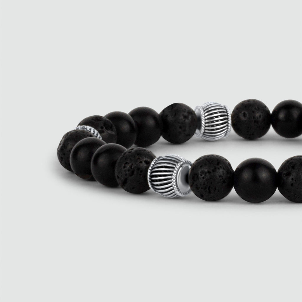 A Kaliq - Adjustable Onyx Black Beaded Bracelet in Silver 6mm with silver accents that fits all.
