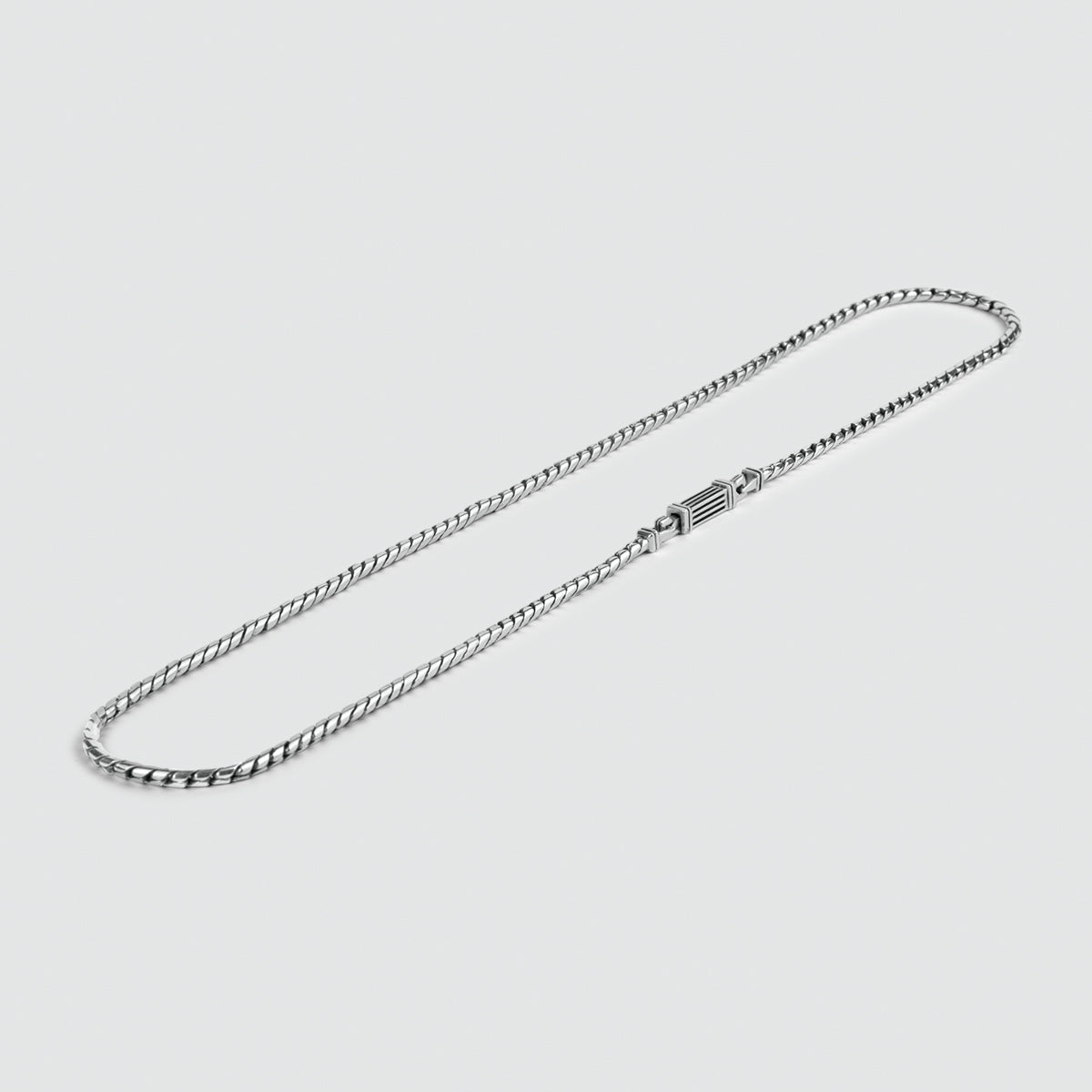 Un collier minimaliste en argent sterling de 2,5 mm, fait à la main, sur fond blanc.