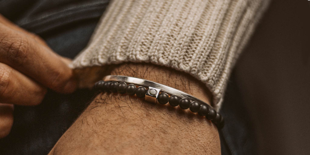 A person's wrist with a bracelet on it.
