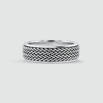 A sterling mens silver ring with a textured, woven basket-like pattern on the outer band, shown on a light gray background. 