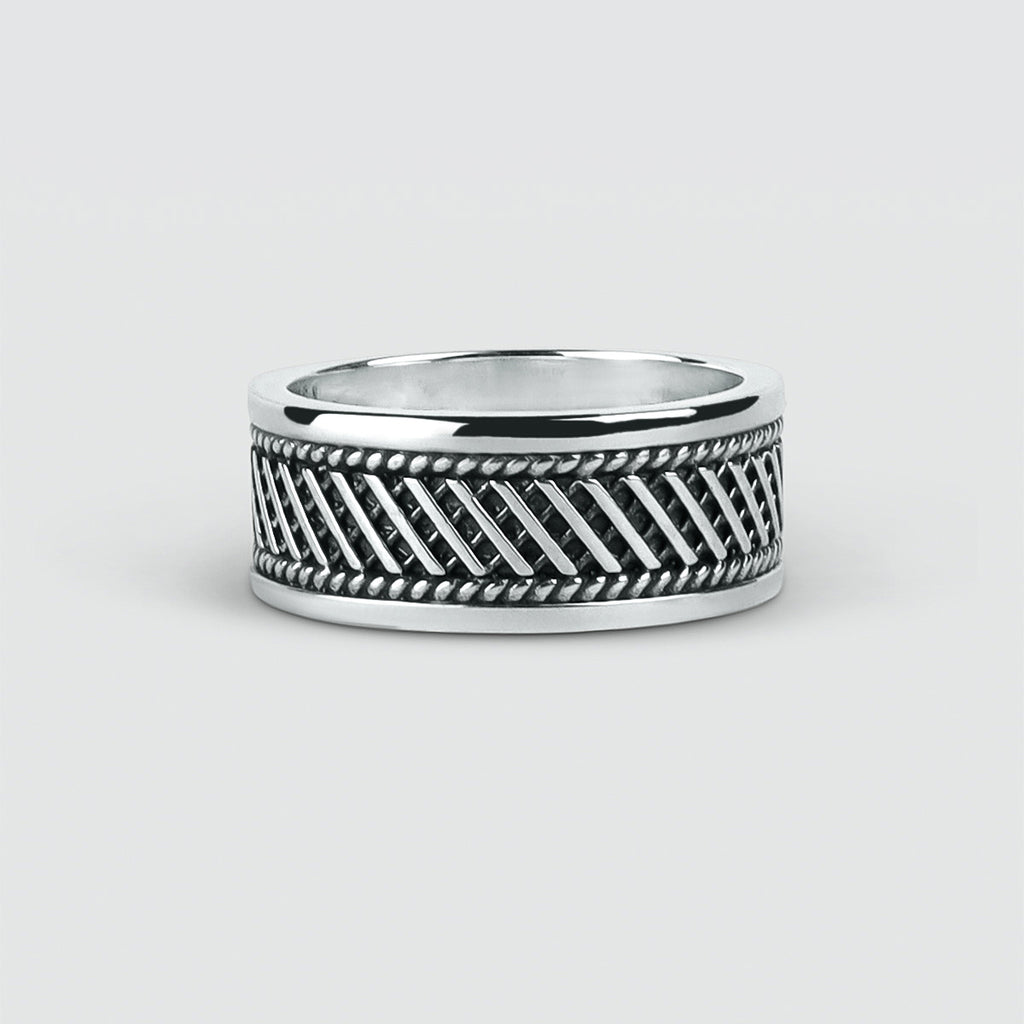 A Kaliq Ring - set silver ring with a black and white pattern.