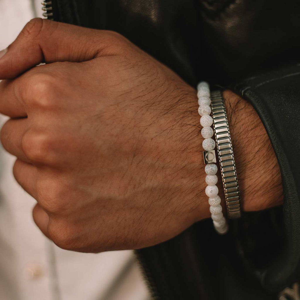 A man wearing a silver bracelet.