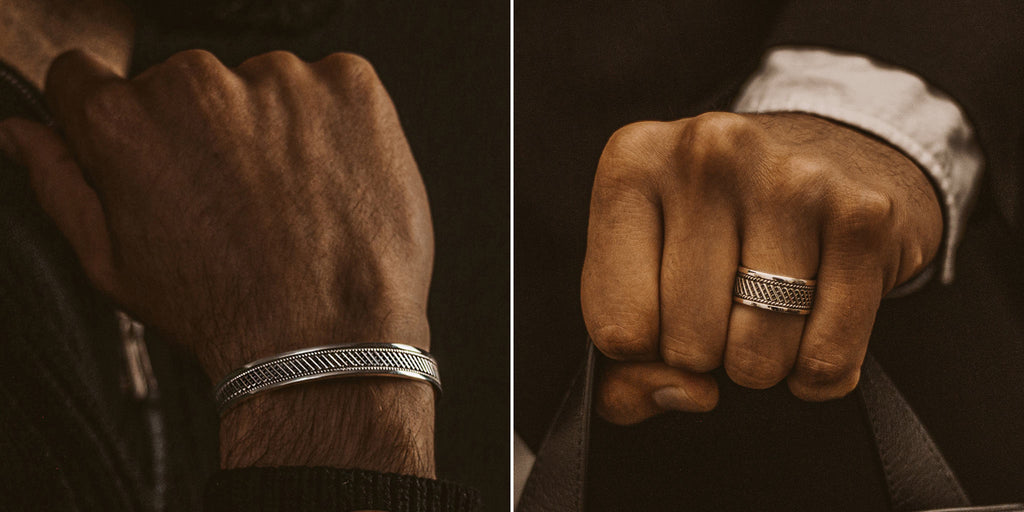 A man wearing a silver ring and a personalised mens bracelet.