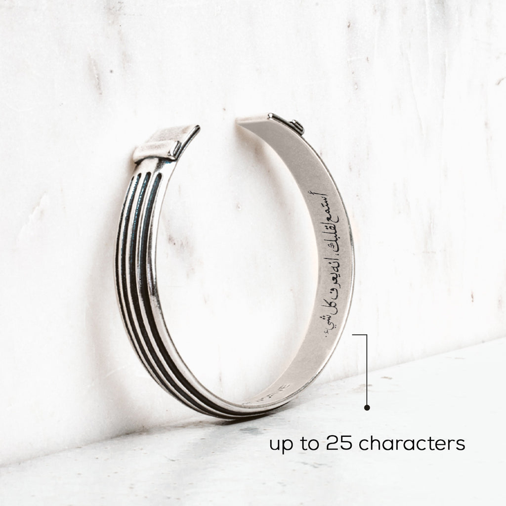 A silver bracelet with the words up to 25 characters.