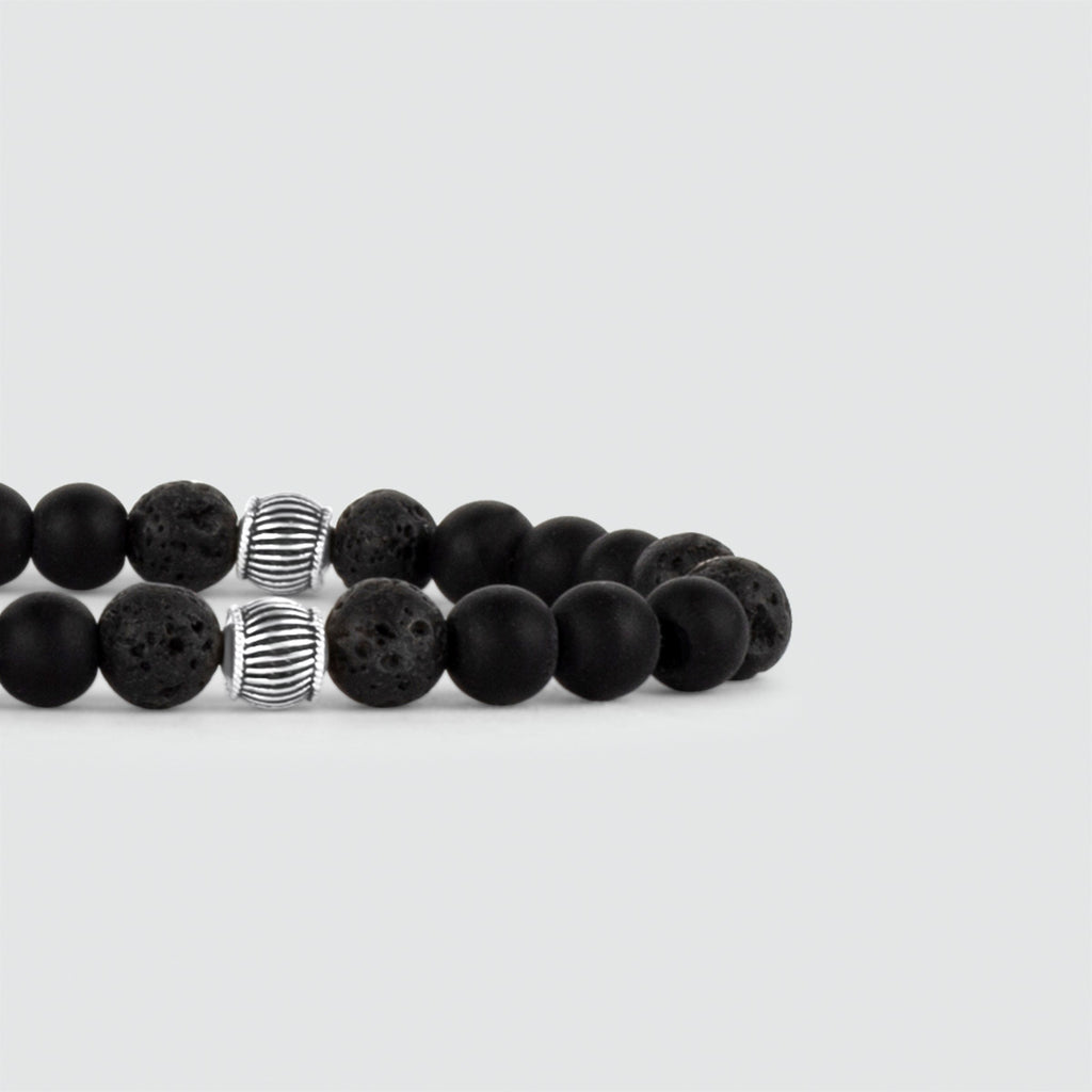A Kaliq - Adjustable Onyx Black Beaded Bracelet in Silver 6mm that fits all, adorned with a single silver bead.