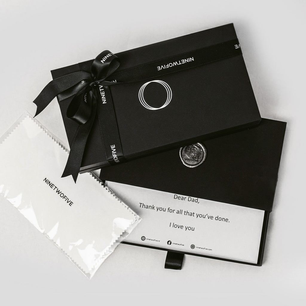Een zwart cadeau box met een gegraveerde Zahir - Sterling Zilveren Veren Ring 6mm.