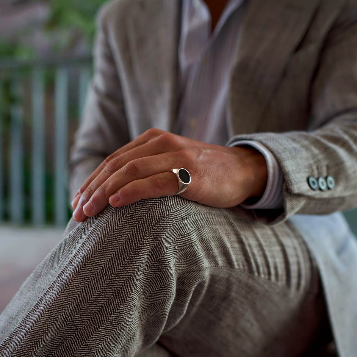 Man wearing Adil 925 silver black onyx signet ring from Ninetowfive on his pinky finger.