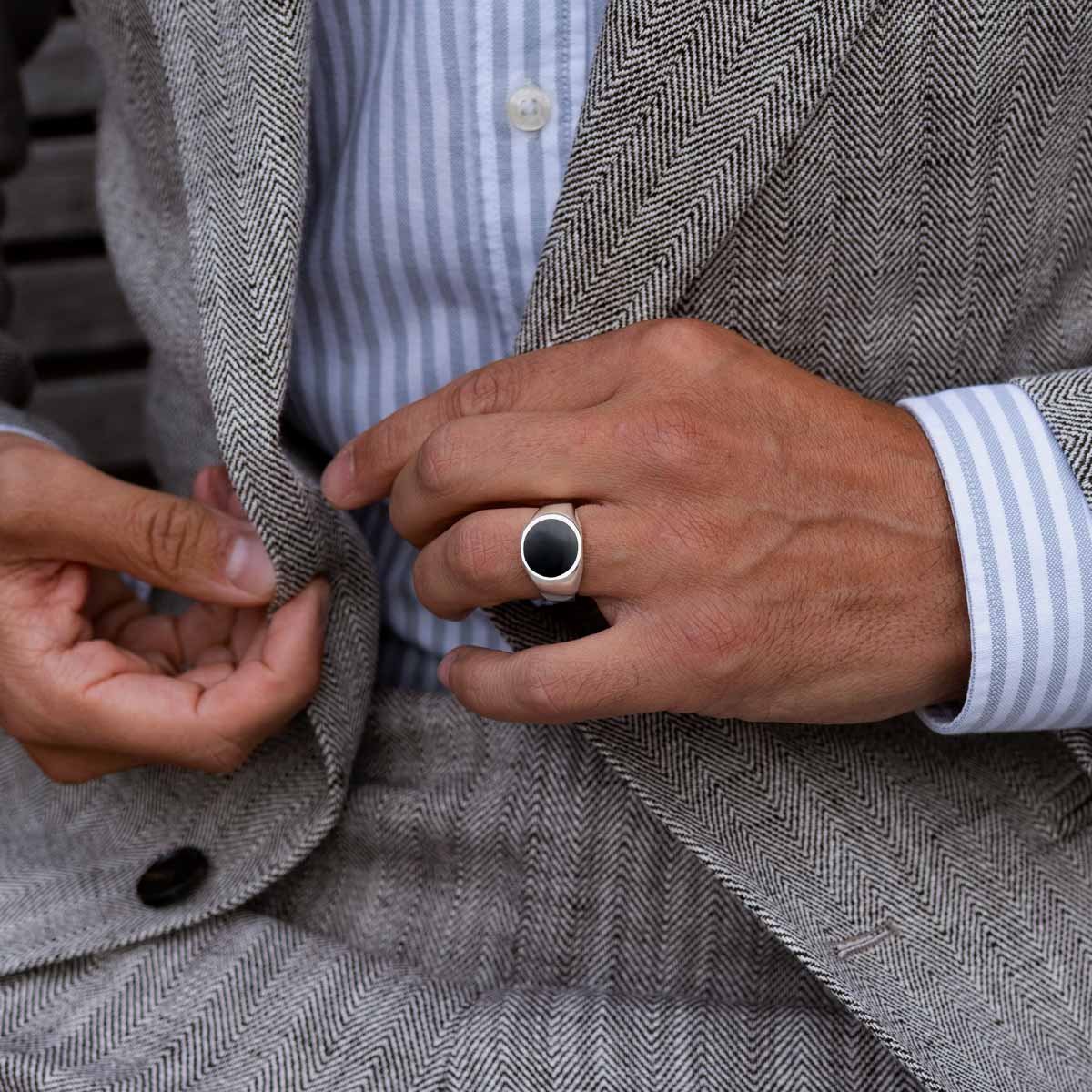 Model wearing 925 silver Adil mens signet ring from Ninetwofive on his ring finger