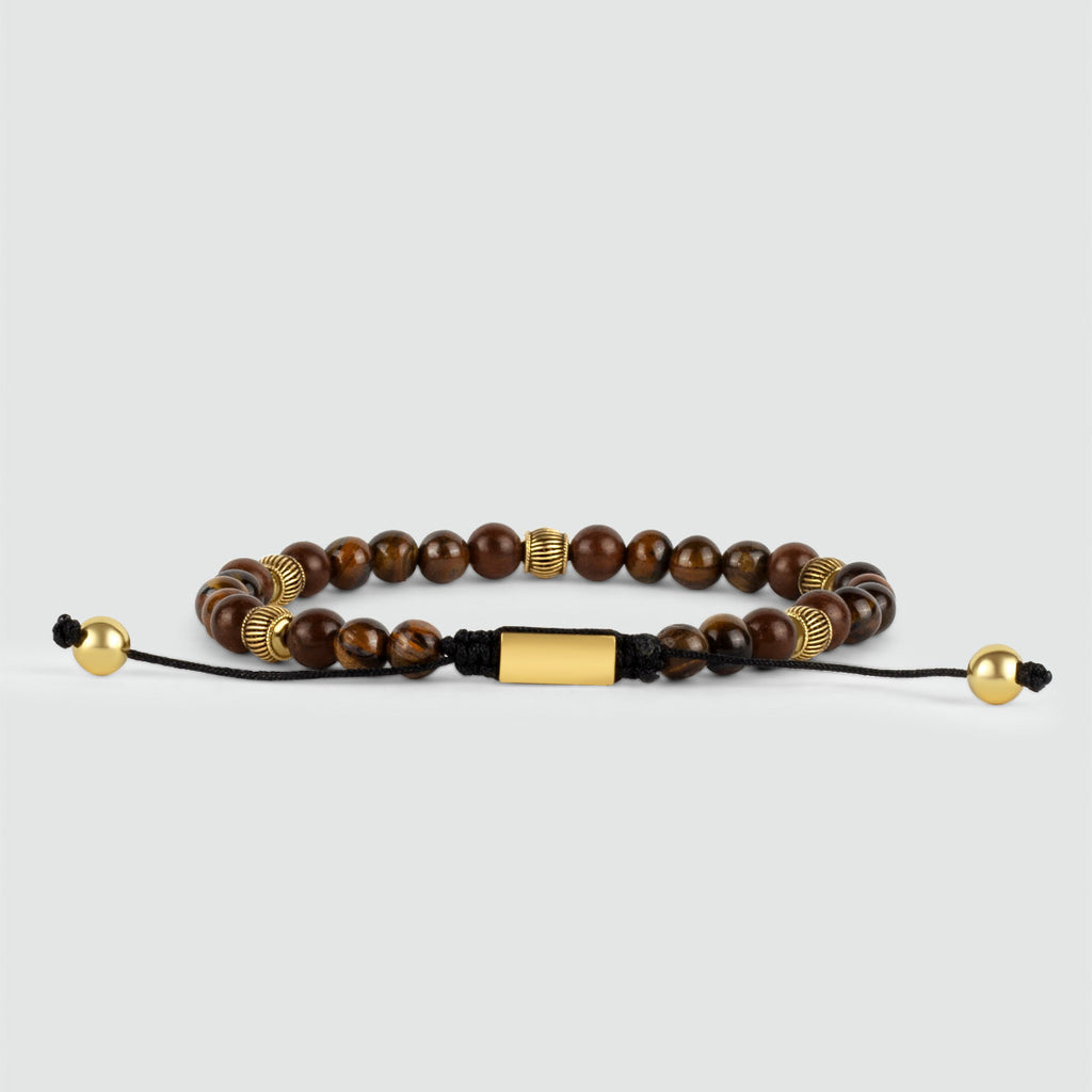 A Kaliq - Adjustable Tiger Eye Beaded Bracelet in Gold 6mm, blending the natural beauty of tiger eye stones with a touch of luxurious 18k gold.