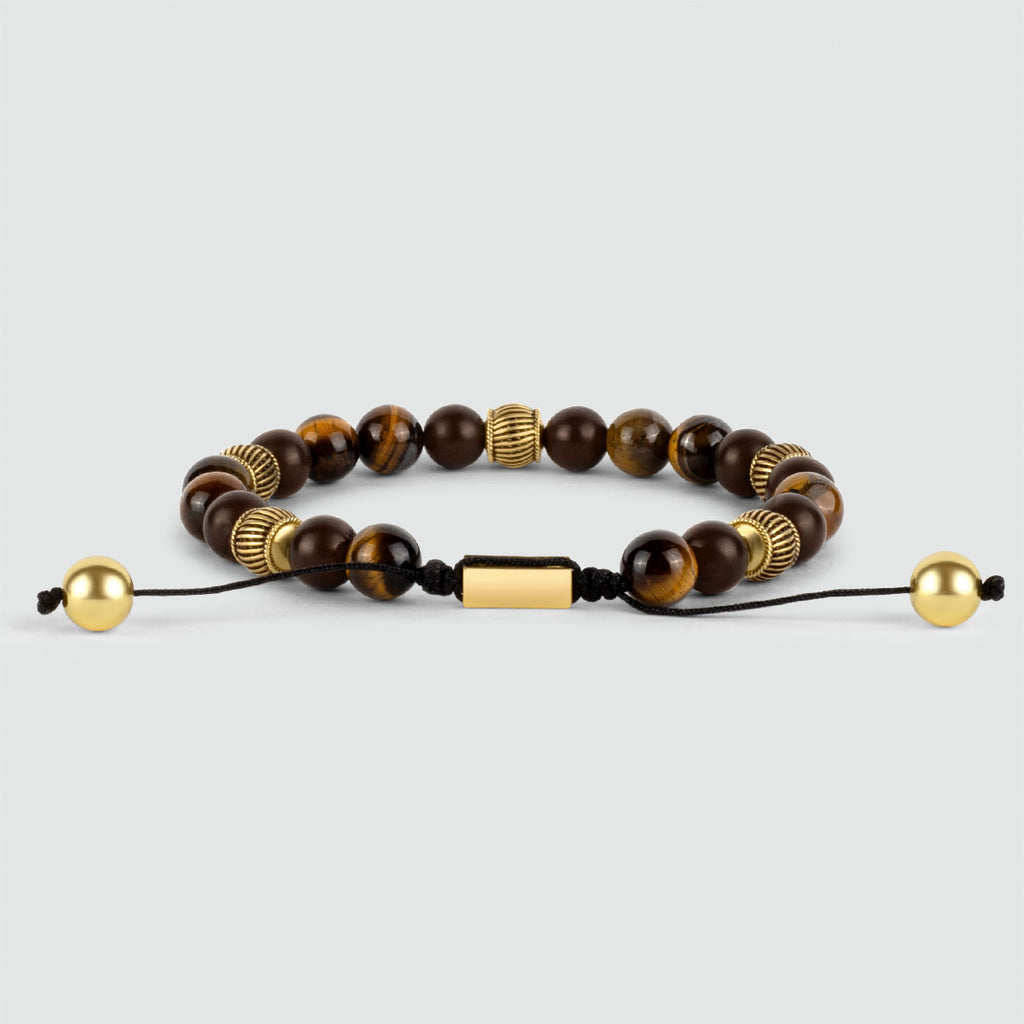 An elegant Kaliq - Adjustable Tiger Eye Beaded Bracelet in Gold 8mm featuring tiger eye beads and a luminous gold bead.