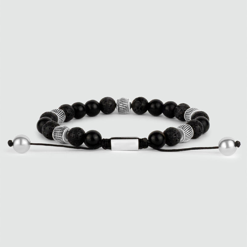A Kaliq adjustable beaded mens bracelet adorned with black onyx and silver beads.