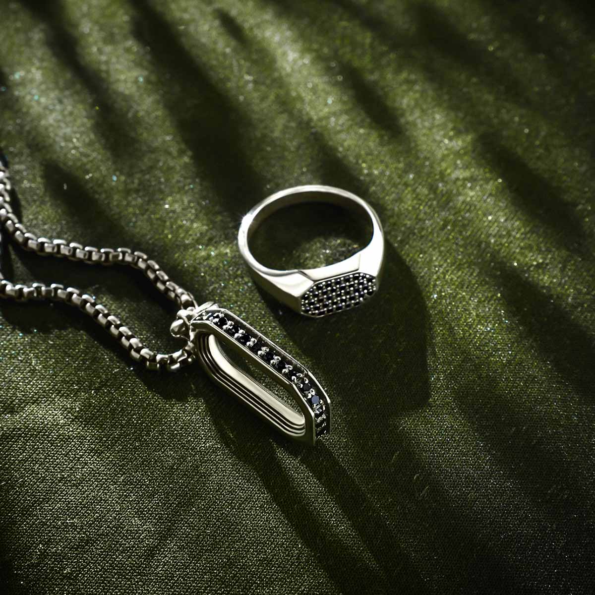 Black diamond Azhar sterling silver men’s signet ring and pendant for men with green background from Ninetwofive.