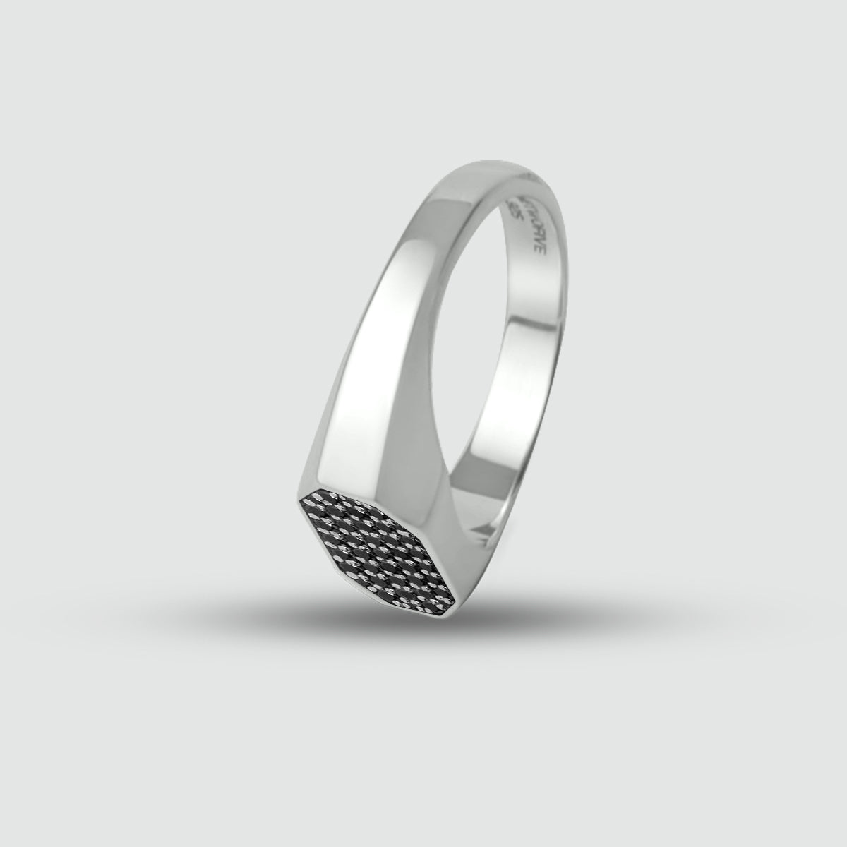 Mens silver signet ring with black diamonds on a light gray background