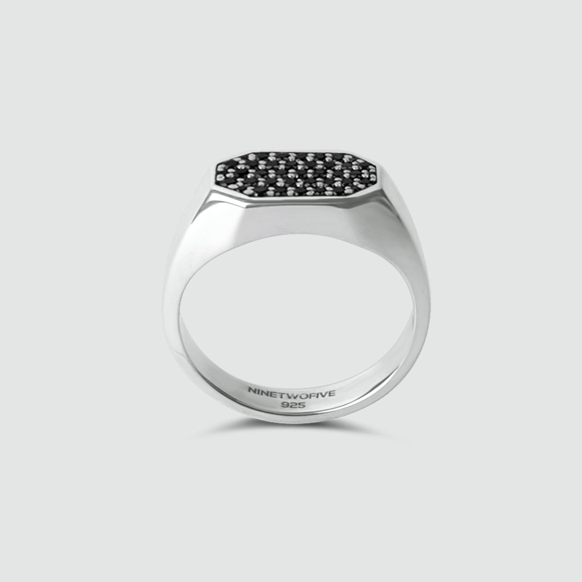 Mens Silver ring with black gemstones on a light gray background