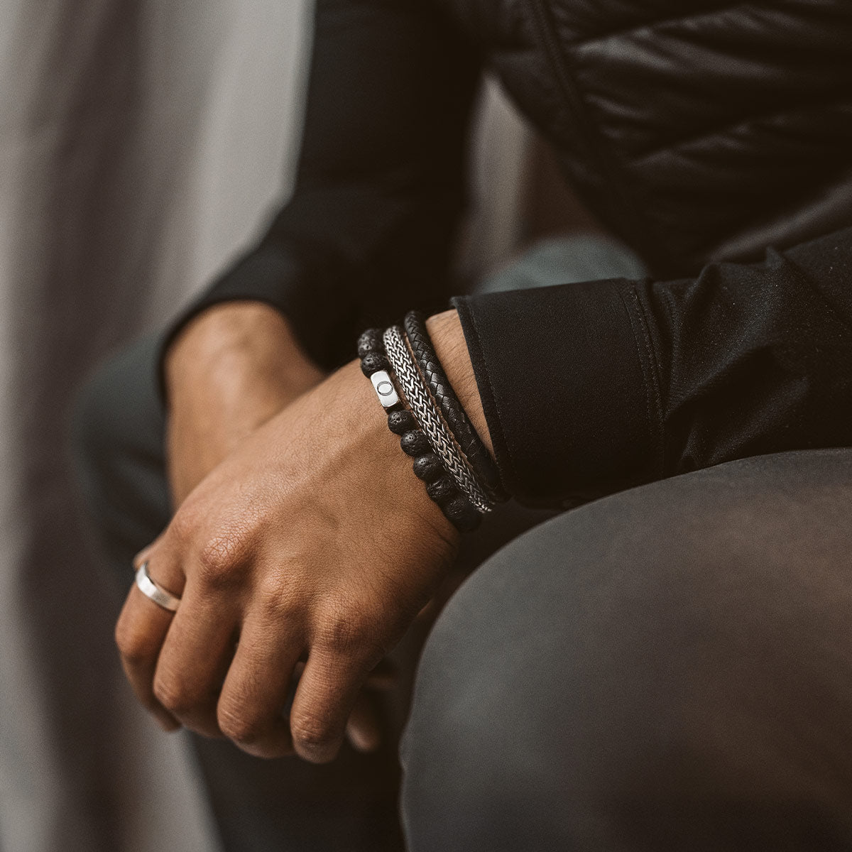 man wearing silver jewellery with a black lava stone bracelet from Ninetwofive