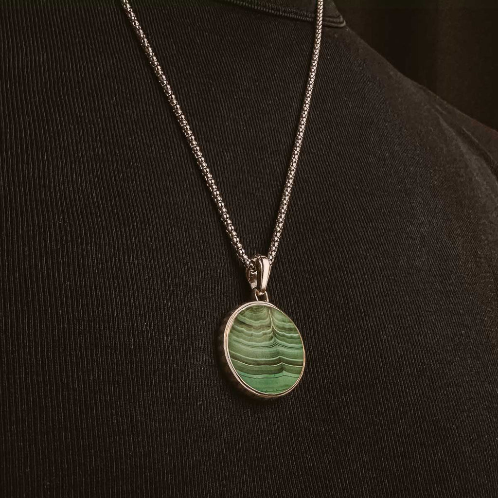 A mens Safar - Sterling Silver Malachite Compass Pendant with a green stone on it.