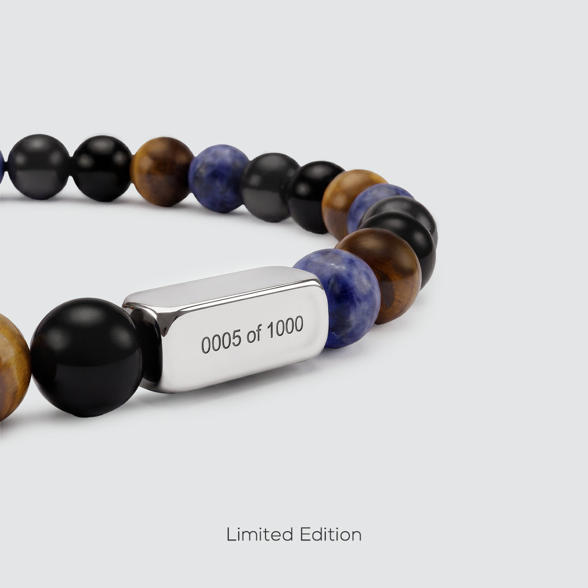 Close-up of limited edition Father’s Day bracelet with engraved stainless steel cube and gemstone beads
