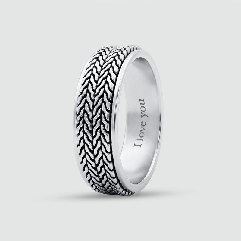 A silver band ring featuring a textured, woven outer pattern and a smooth, polished inner band engraved with the words 'I love you', shown on a light gray background.