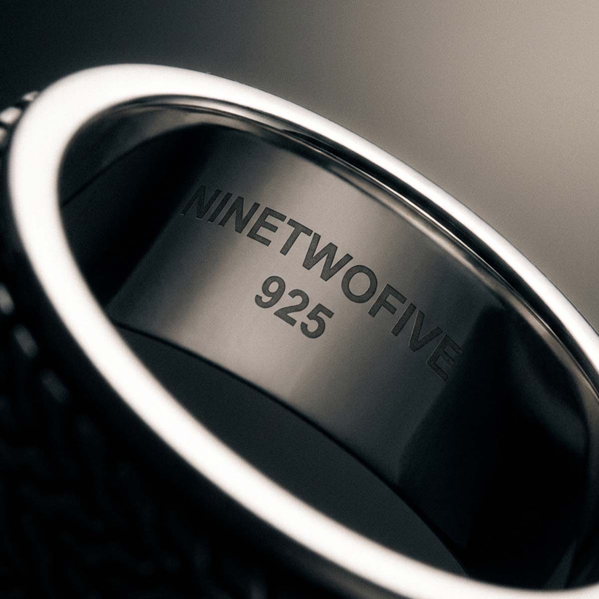 Mood shot of the Hani sterling silver spinner ring with its herringbone pattern
