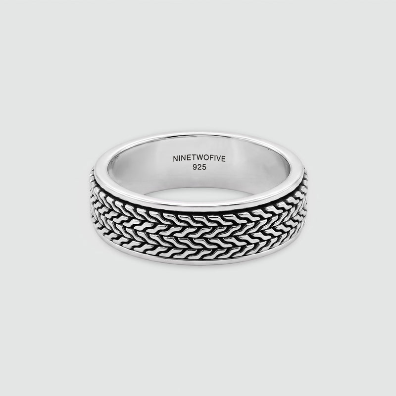 Hani silver spinner ring at an angle, showing the 925 hallmark inside the band