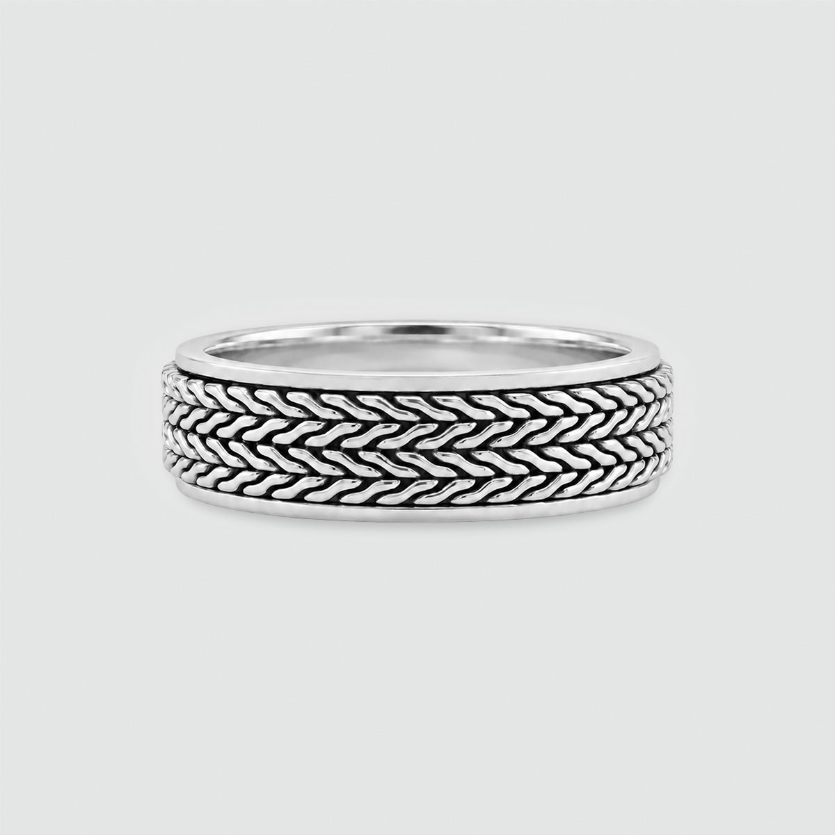 Hani sterling silver spinner ring, front view of the oxidised herringbone outer band