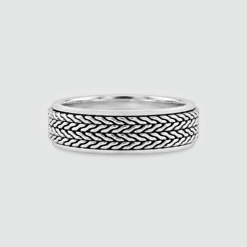 Hani sterling silver spinner ring, front view of the oxidised herringbone outer band