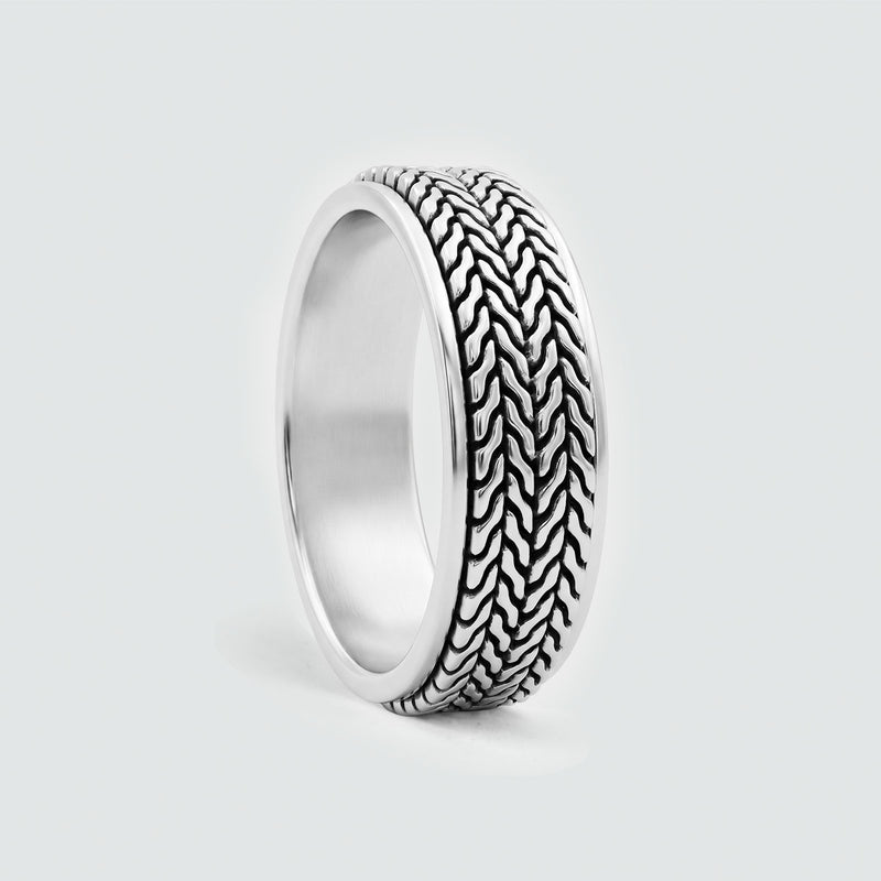 Side view of the Hani sterling silver spinner ring with its oxidised herringbone band