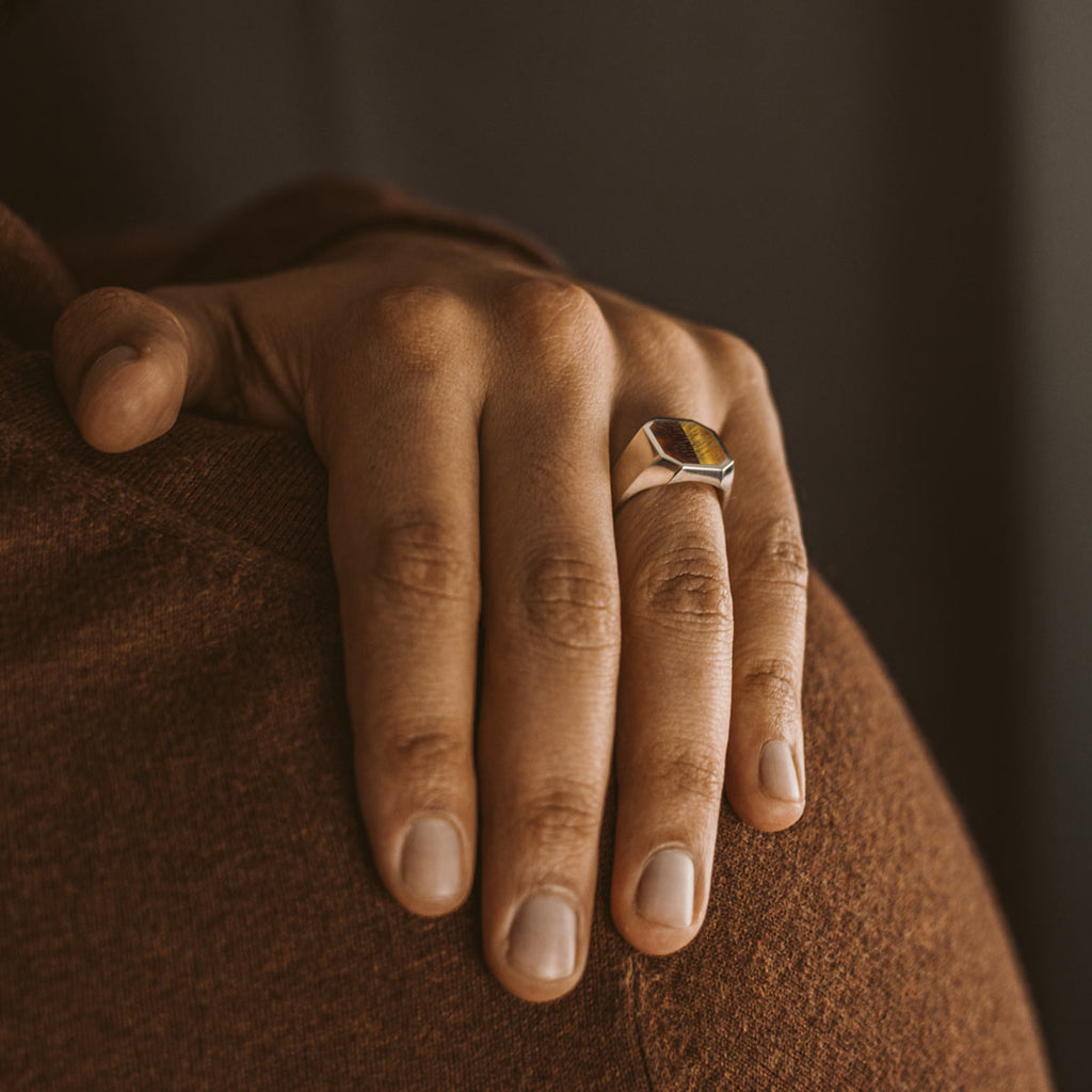 A person wearing a ring with a triangle on it.