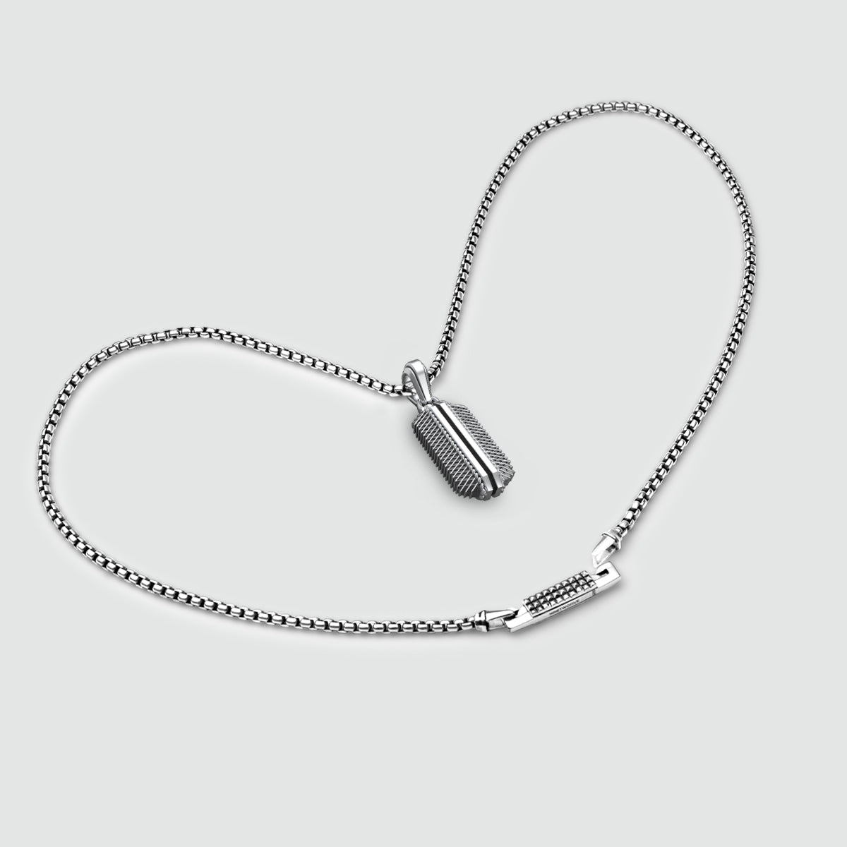 Top view of Berlin architecture-inspired design on Kaliq sterling silver pendant and mens chain by Ninetwofive.