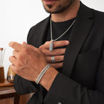 Model wearing Kaliq 925 silver bracelet, ring, and pendant, styled with a black blazer. Ninetwofive.