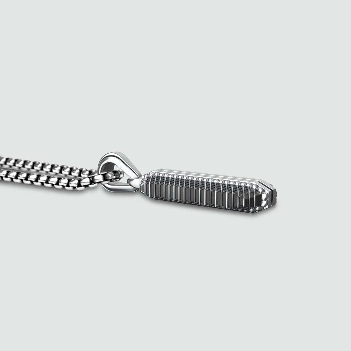 Side view of high polished Kaliq oxidised sterling silver pendant from Ninetwofive