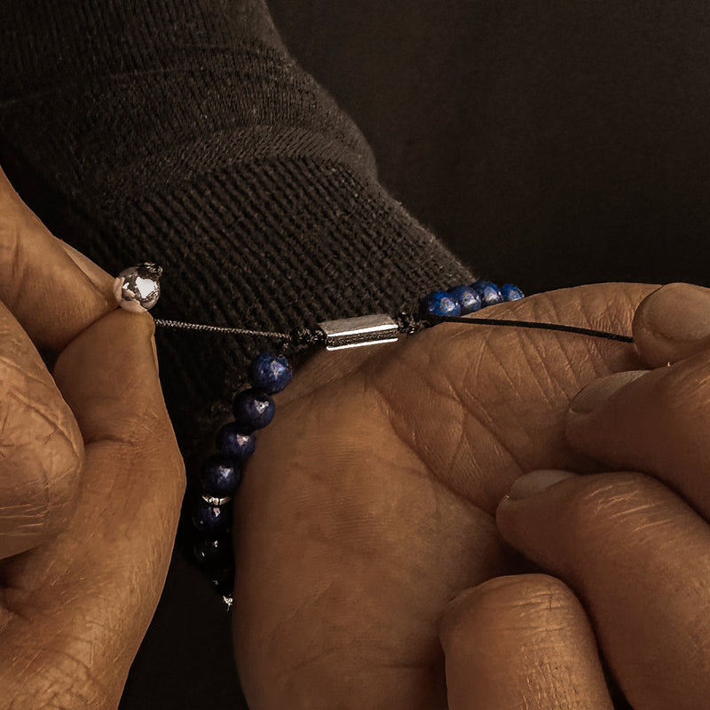 Man in black sweater adjusting Kadar mens beaded bracelet by Ninetwofive.