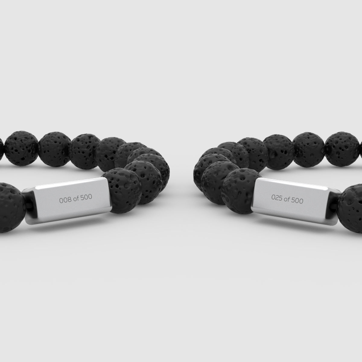 angle view of the lava stone two bracelets for men from Ninetwofive with engraved numbers in front.