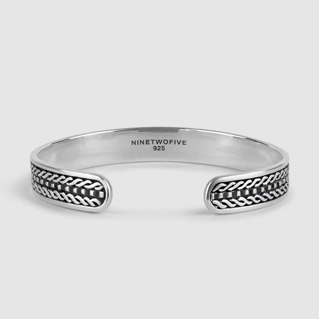 A personalised Fariq - Oxidized Sterling Silver Bangle 10mm with a braided design.